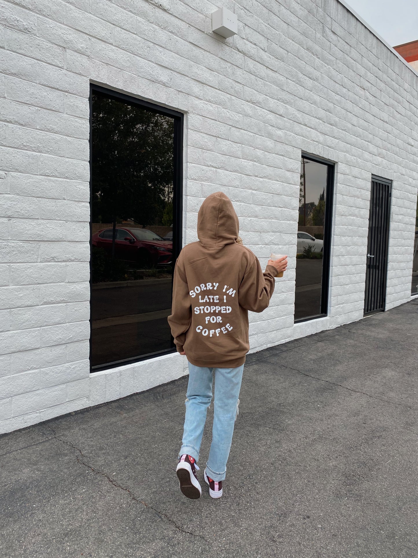 brown "SORRY I'M LATE I STOPPED FOR COFFEE" hoodie